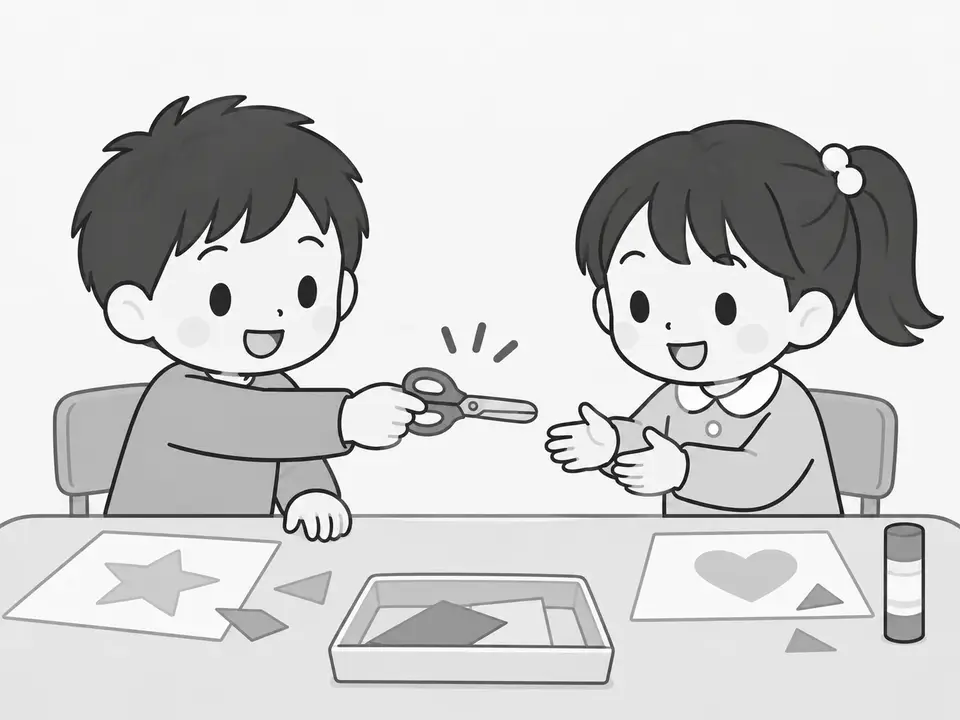 工作の机で、左の男の子がはさみを女の子に差し出しています。はさみの刃先が右の女の子の方を向いています。女の子は手を伸ばしています。